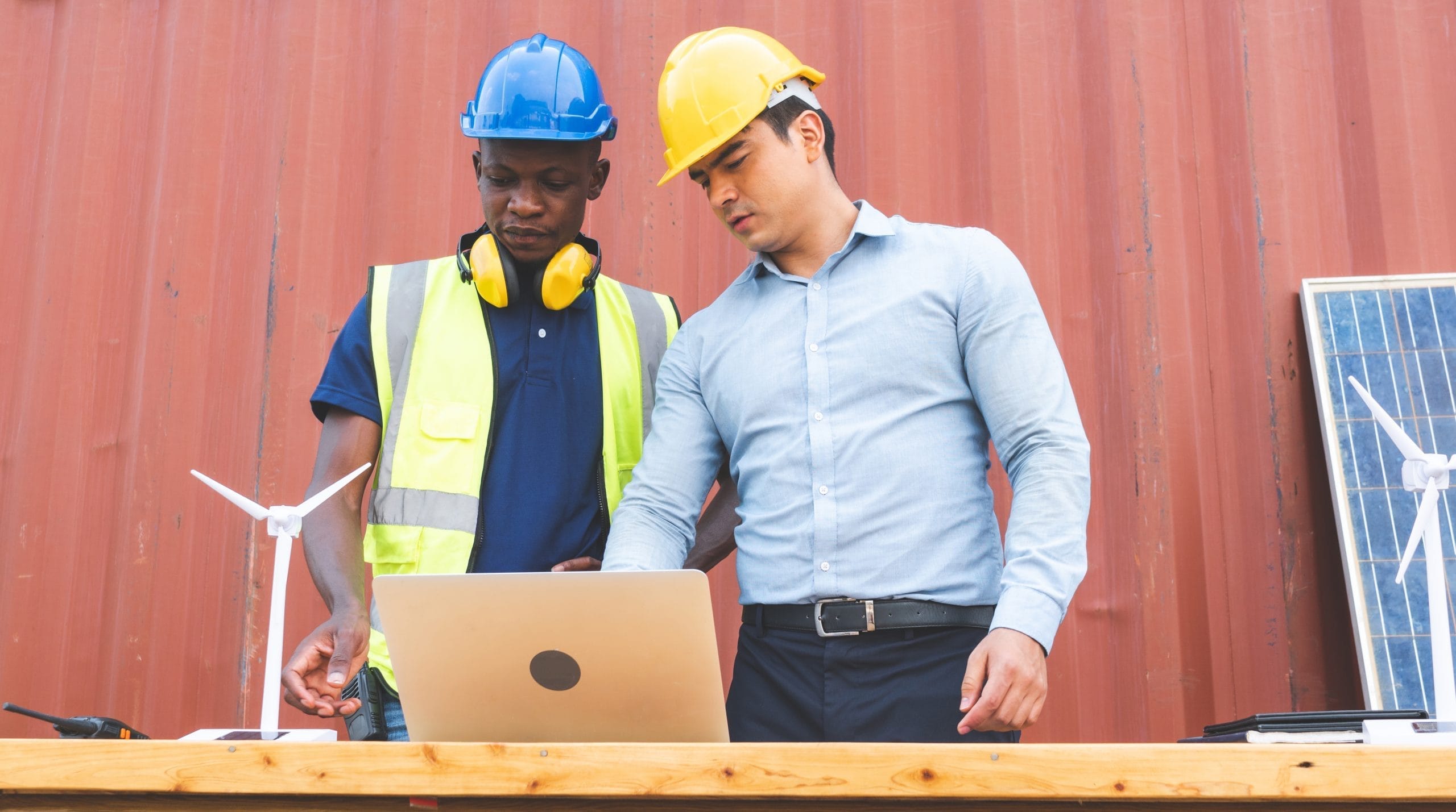 Engineer and African American worker discussing of solar energy